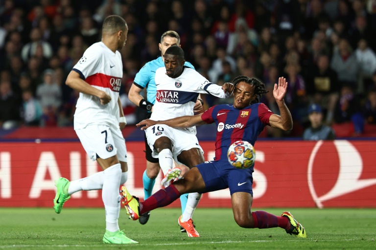 L'attaquant du PSG Ousmane Dembele aux prises avec son partenaire de l'équipe de France Jules Koundé, sous le maillot du Barça mardi en quart de finale retour de Ligue des champions à Barcelone.