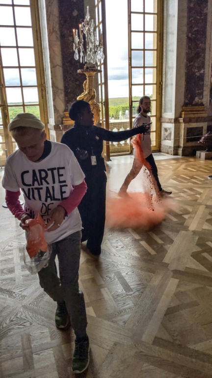 Des militants de Riposte alimentaire jetent de la poudre orange dans la galerie des glaces du château de Versailles, le 4 mai 2024