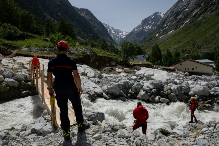 Des secouristes sécurisent une passerelle au-dessus d'une rivière après une crue dévastatrice de la rivière Veneon, le 21 juin 2024, dans le hameau de La Berarde, le 28 juin 2024 en Isère