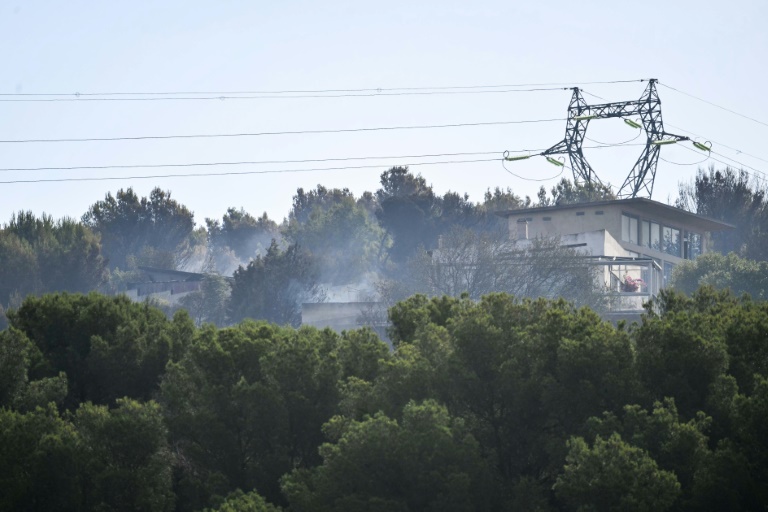 La fumée d'un incendie de forêt près de bâtiments à Saint-Julien Les Martigues, au nord-ouest de Marseille, le 18 juillet 2025 dans les Bouches-du-Rhône