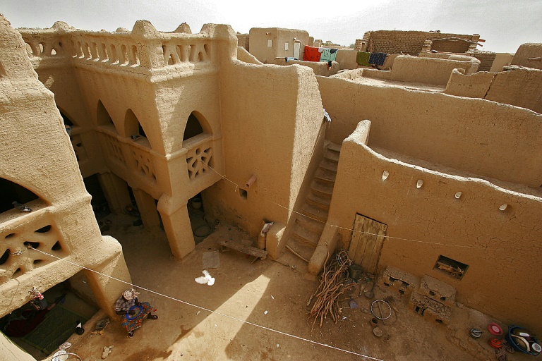 Une femme se repose dans la cour intérieure d'une vaste maison construite en terre battue, le 9 février 2005 à Djenné, dans le centre du Mali