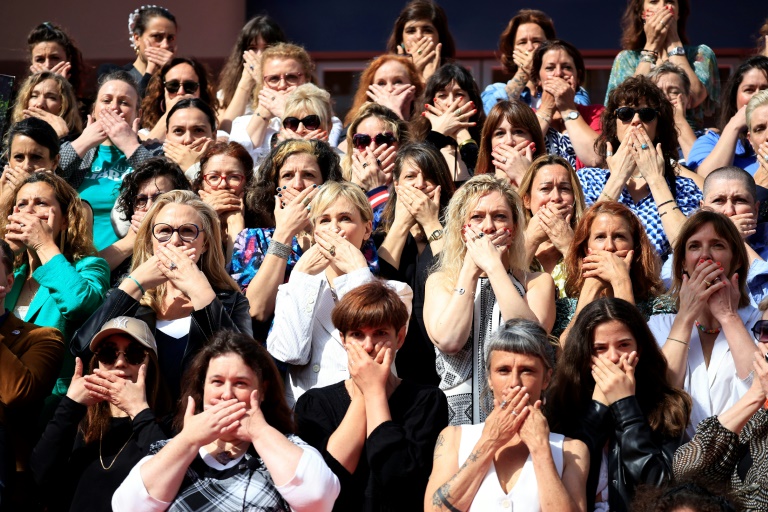 L'actrice Judith Godrèche (c), figure du mouvement #MeToo en France, manifeste avec des membres d'associations de lutte contre les violences faites aux femmes, sur les marches du Palais des Festivals à Cannes, le 16 mai 2024