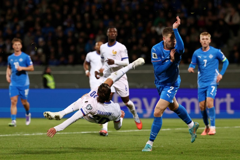 L'attaquant français Florian Thauvin (au centre) tente un ciseau spectaculaire en qualifications du Mondial 2022 contre l'Islande le 13 octobre 2025 à Reykjavik