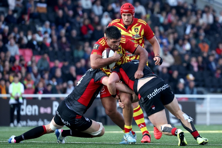 Le troisième ligne argentin de Perpignan Joaquin Oviedo (au centre) est stoppé par deux joueurs de Lyon le 11 octobre 2025, lors de la 6e journée du Top 14, au stade Gerland