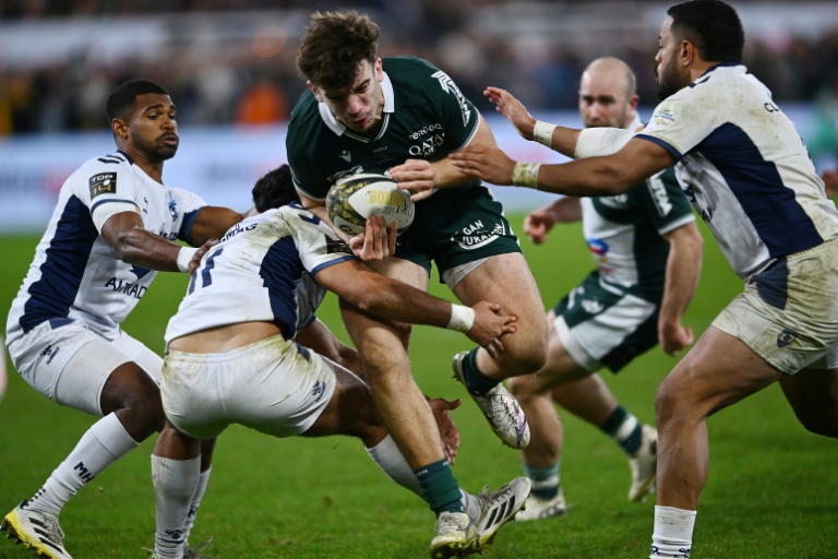 Le centre de Pau Fabien Brau-Boirie (au centre) est difficilement plaqué par les joueurs de Montpellier, au stade du Hameau, le 28 décembre 2025