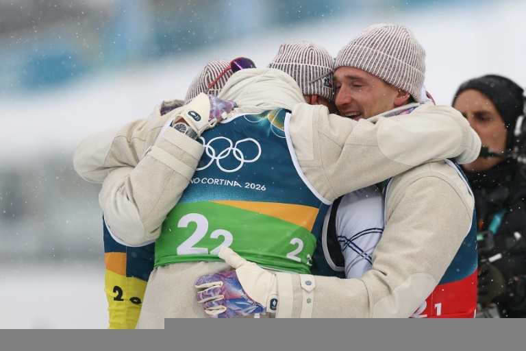 Les Français Eric Perrotis, Quentin Fillon Maillet, Emilien Jacquelin et Fabien Claude se congratulent après leur victoire dans le relais 4 x 7,5 km du biathlon des JO-2026 à Anterselva le 17 février 2026 en Italie