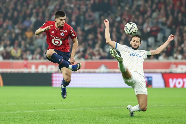 Le joueur de Lille Matias Fernandez-Pardo (G), buteur lors du match nul contre Lorient (1-1), à la lutte avec le défenseur lorientais Montassar Talbi, le 8 mars 2026 au stade Pierre-Mauroy de Villeneuve-d'Ascq