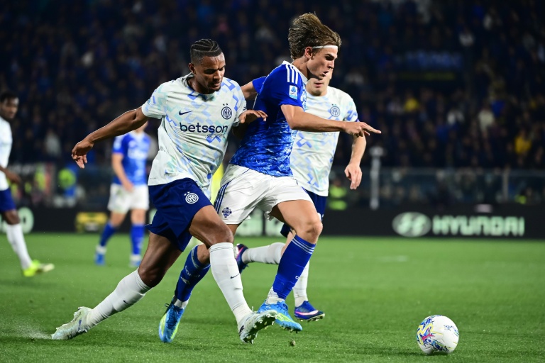 Le miliei offensif de Côme Nico Paz s'infiltre entre deux défenseurs de l'Inter Milan en Serie A le 12 avril 2026 au stade Giuseppe Sinigaglia à Côme