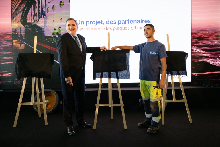 Le ministre des Transports Philippe Tabarot (G) et un ouvrier du scteur portuaire lors de l'inauguration du dispositif de branchement électrique des bateaux de croisière, le 11 avril 2026 à Marseille