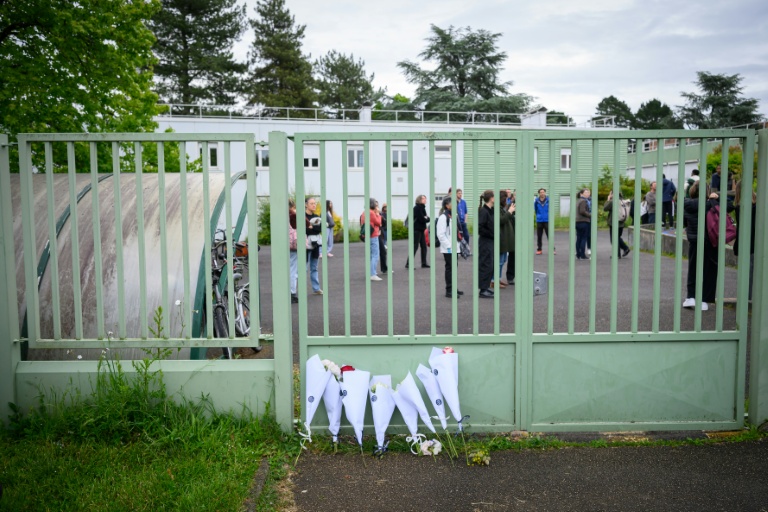 Des fleurs déposées devant la grille du collège Libertaire Rutigliano en hommage à l'adolescent de 15 ans tué lors d'une fusillade, le 18 mai 2026 à Nantes