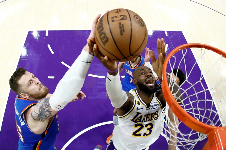 LeBron James (c.), l'ailier fort des Lakers de Los Angeles, monte au panier face à Isaiah Hartenstein (g.), le pivot  du Thunder d'Oklahoma City, lors du troisième match du deuxième tour des play-offs de la Conférence Ouest de la NBA, à Los Angeles, le 9 mai 2026