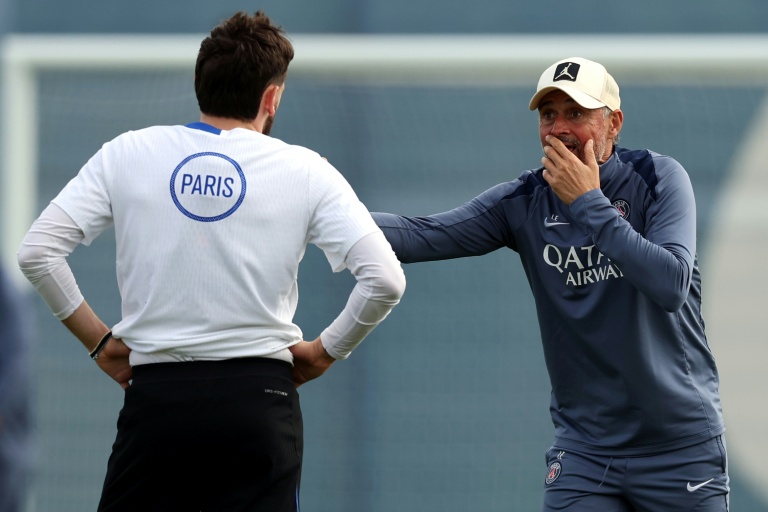 Luis Enrique (d) donne des instructions à l'attaquant du Paris SG Khvicha Kvaratskhelia lors d'un entraînement en vue de la finale de Ligue des champions contre Arsenal, le 20 mai 2026 à Poissy