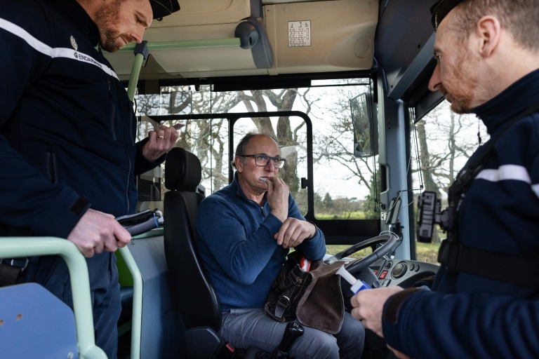 Un chauffeur de bus scolaire effectue un test salivaire lors d'un contrôle routier de gendarmerie à Auray, dans le Morbihan, le 6 février 2025