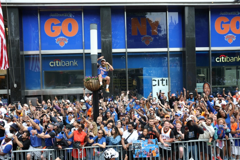 Des milliers de personnes saluent le passage de l'équipe des Knicks, lors de la parade organisée à New York pour célébrer sa victoire en finale NBA, le 18 juin 2026.