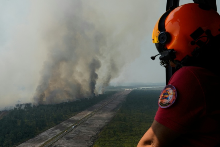 Un hélicoptère de la sécurité civile survole l'incendie près d'Ares (Gironde) le 29 juillet 2026