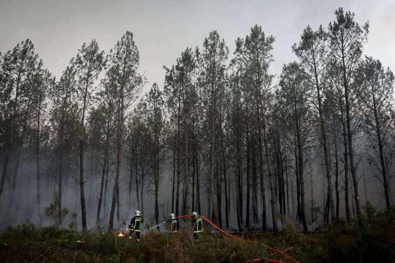 Des pompiers luttent contre un incendie de forêt à Saint-Jean-d'Illac, à environ 30 km de Bordeaux, alors qu'un feu de forêt ravage la forêt au nord du bassin d'Arcachon en Gironde, le 26 juillet 2026