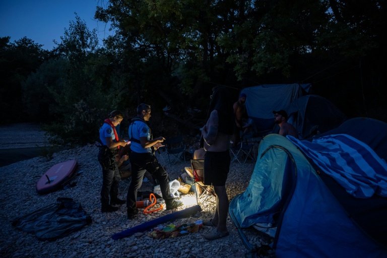 Des gendarmes contrôlent des touristes lors d'une opération de prévention contre les bivouacs illégaux susceptibles de provoquer un départ de feu, le 8 août 2026 autour du lac de Sainte-Croix, aux portes des Gorges du Verdon
