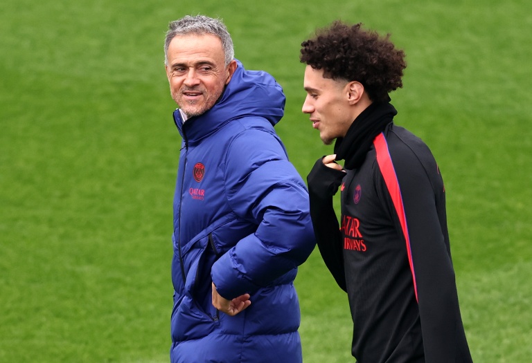 L'entraîneur du PSG Luis Enrique (g) discute avec son attaquant Maghnes Akliouche lors d'un entraînement, le 19 octobre 2026 à Poissy
