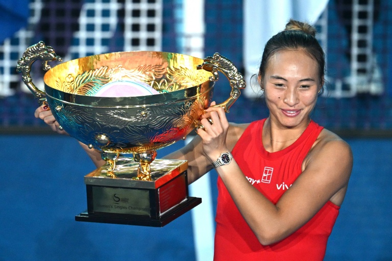Zheng Qinwen célébrant sa victoire au WTA 1000 de Pékin avec le trophée.
